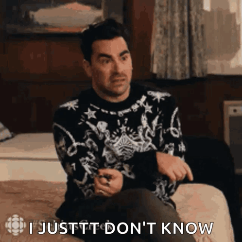 Man in Sweater Sitting on Bed Saying I Justtt Don't Know