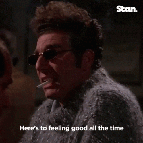 Man In Sweater Smoking Cigarette Saying Cheers GIF
