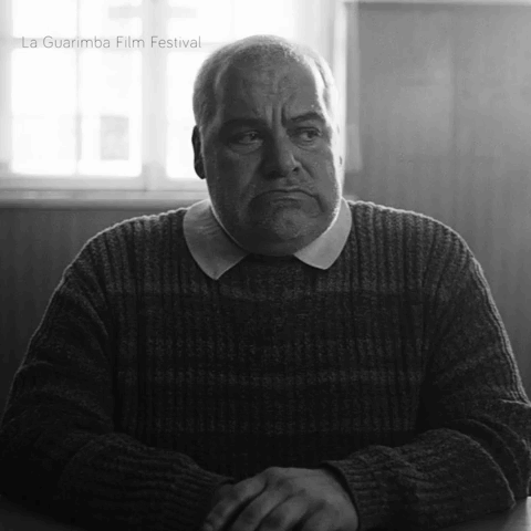 Man in Sweater with La Guarimba Film Festival Watermark