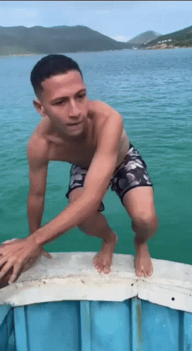 Man in Swim Trunks Standing on Dock