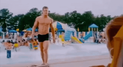 Man in Swim Trunks Walking Water Park