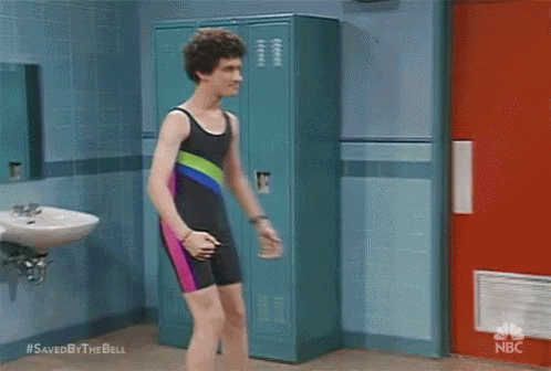 Man In Swimsuit Beside Lockers In Bathroom GIF
