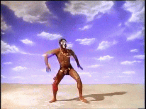 Man In Swimsuit Dancing In Desert GIF