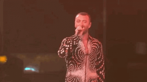 Man in Swirl Shirt Singing on Stage