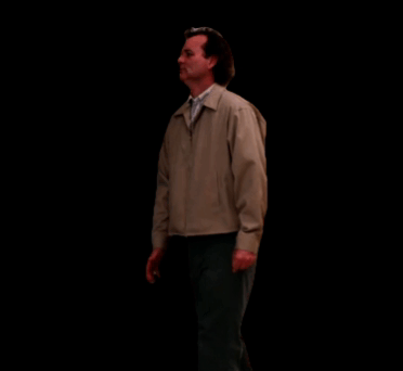 Man In Tan Jacket And Black Pants Walking In Dark Room GIF