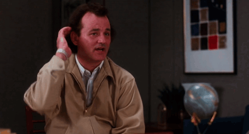 Man In Tan Jacket Sitting At Table GIF