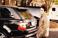 Man in Tan Jacket With Black Range Rover