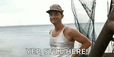 Man In Tank Top And Hat Standing On Boat GIF