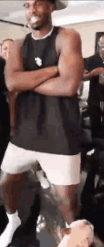 Man in Tank Top and Shorts Standing