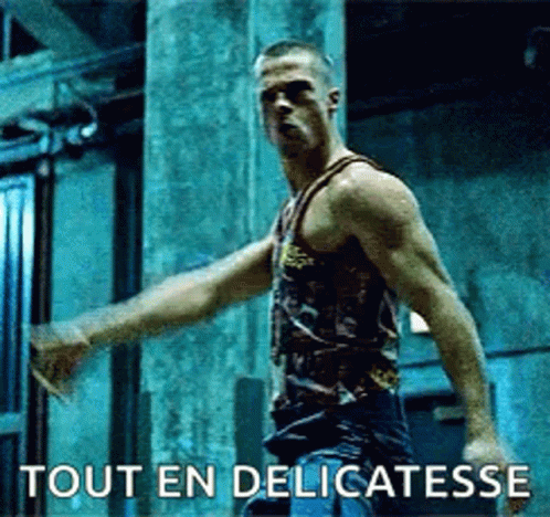 Man In Tank Top Arms Outstretched Says Tout En Delicatesse GIF
