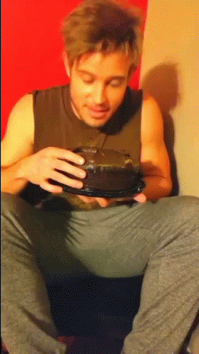 Man in Tank Top Holding Cake