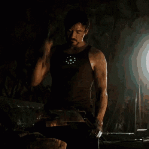 Man In Tank Top Holding Hammer GIF