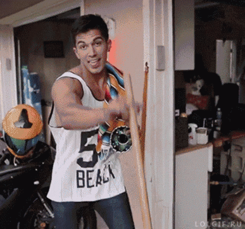 Man in Tank Top Holding Skateboard