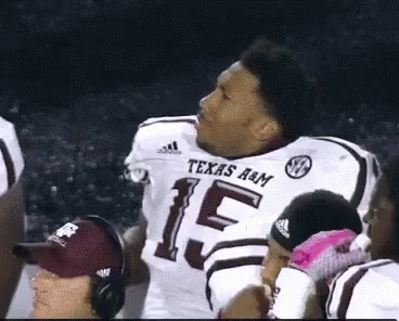 Man in Texas A&M Football Jersey With Teammates