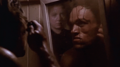 Man In The Mirror Combing Hair GIF