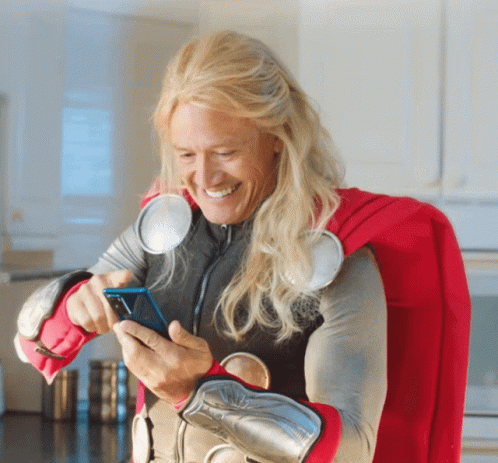 Man in Thor Costume Looking at Phone