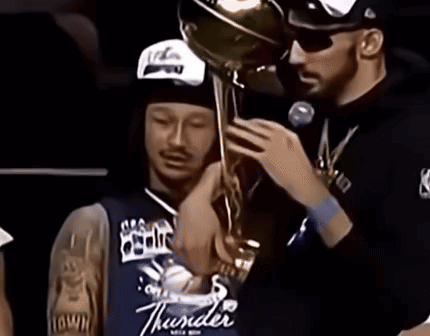 Man in Thunder Jersey Holding Trophy Over Another Man