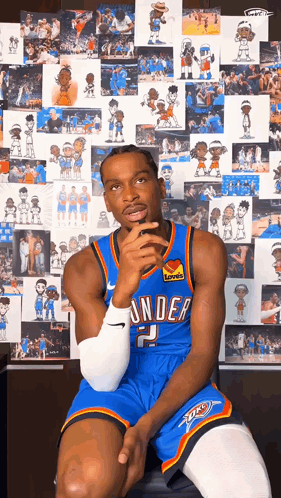 Man in Thunder Jersey Sitting in Front of Picture Wall