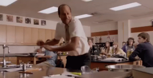 Man in Tie Dancing in Classroom