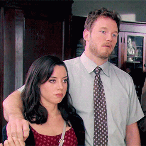 Man in Tie Next to Woman in Red Dress
