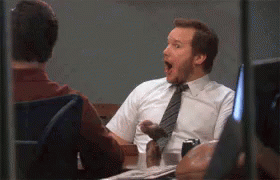 Man In Tie Sitting At Desk With Mouth Open GIF