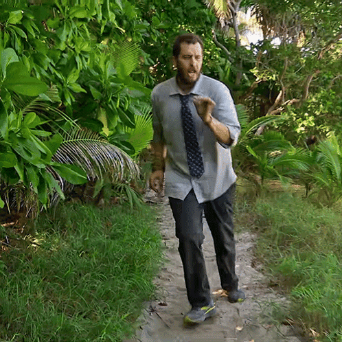 Man in Tie Walking Down Dirt Path