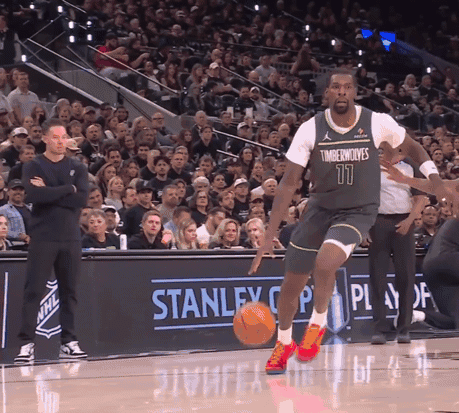 Man in Timberwolves Jersey Dribbling Basketball