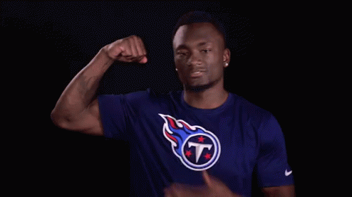 Man In Titans Shirt Flexing Arm GIF
