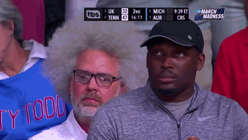 Man in Todd Sweater Watching Game
