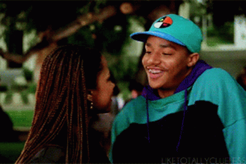 Man in Tommy Hilfiger Hat Smiling Next to Woman