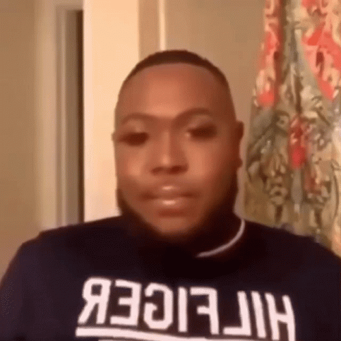 Man in Tommy Hilfiger Shirt Looking at Camera