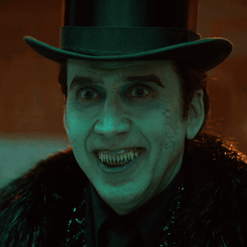 Man In Top Hat And Fur Coat With Painted Teeth GIF
