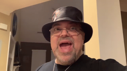 Man in Top Hat and Glasses Making Face