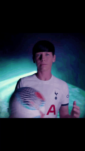 Man in Tottenham Shirt Holding Soccer Ball