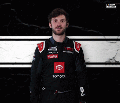 Man in Toyota Racing Suit in Front of NASCAR Logo
