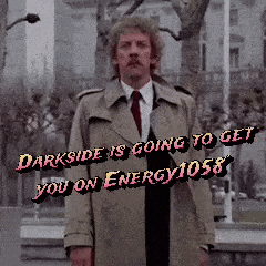 Man In Trench Coat In Front Of Darkside Is Going To Get You On Energy 1058 Sign GIF