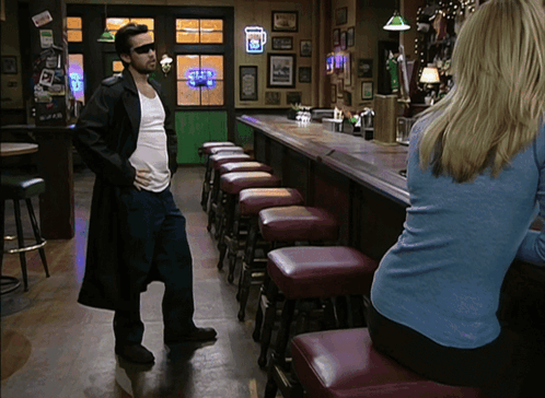 Man In Trench Coat In Front Of Guinness Bar GIF