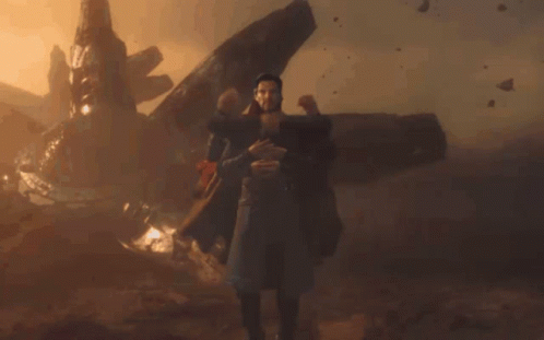 Man In Trench Coat Surrounded By Arms GIF