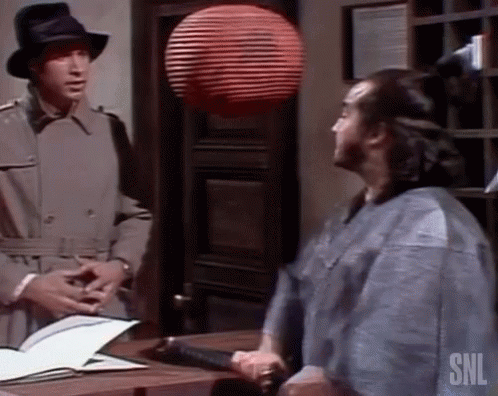 Man in Trench Coat Talking to Man in Kimono