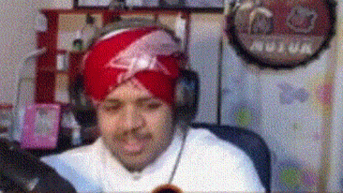 Man in Turban and Headphones at Computer
