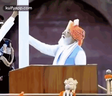 Man in Turban Giving Speech at Podium