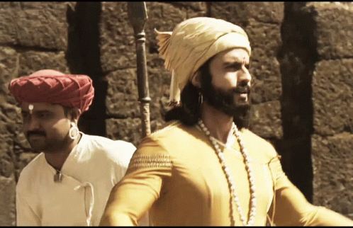 Man In Turban Next To Man In Yellow Shirt GIF