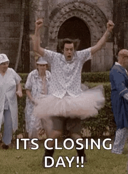 Man in Tutu Jumping Behind Group of People