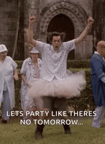 Man in Tutu Jumping in Air With Group Behind
