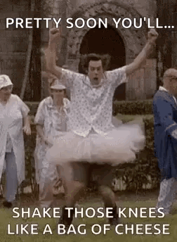 Man in Tutu Jumping While People Watch