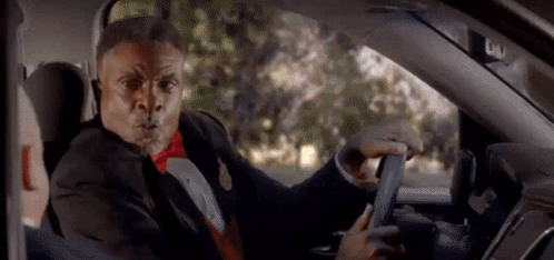 Man in Tuxedo and Bow Tie Driving Car Funny Face