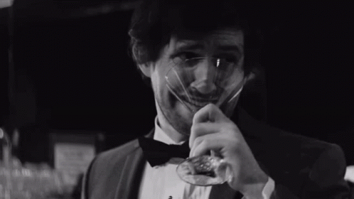 Man in Tuxedo and Bow Tie Holding Glass