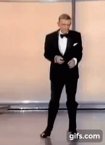 Man In Tuxedo And Bow Tie On Stage GIF