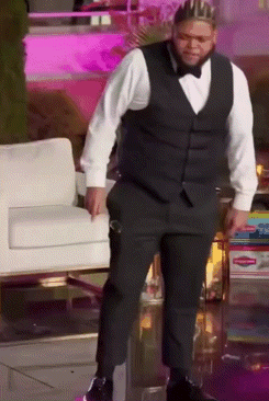 Man in Tuxedo and Crown by Chair