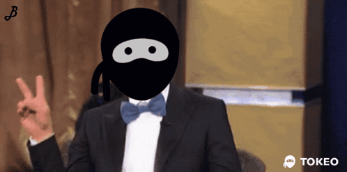 Man in Tuxedo and Ninja Mask Giving Peace Sign